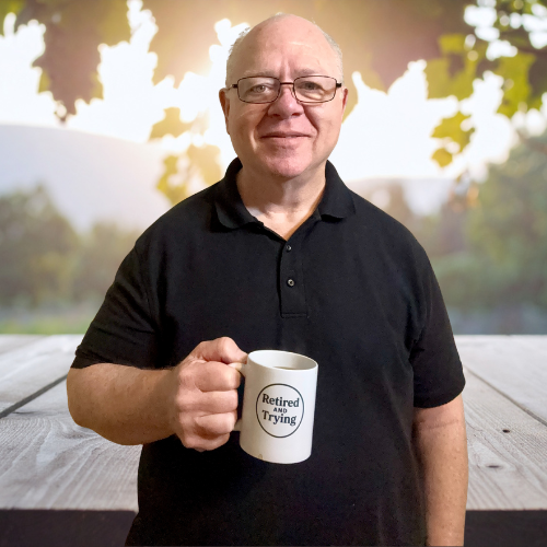 Retired man holding cup of coffee with scenic background.